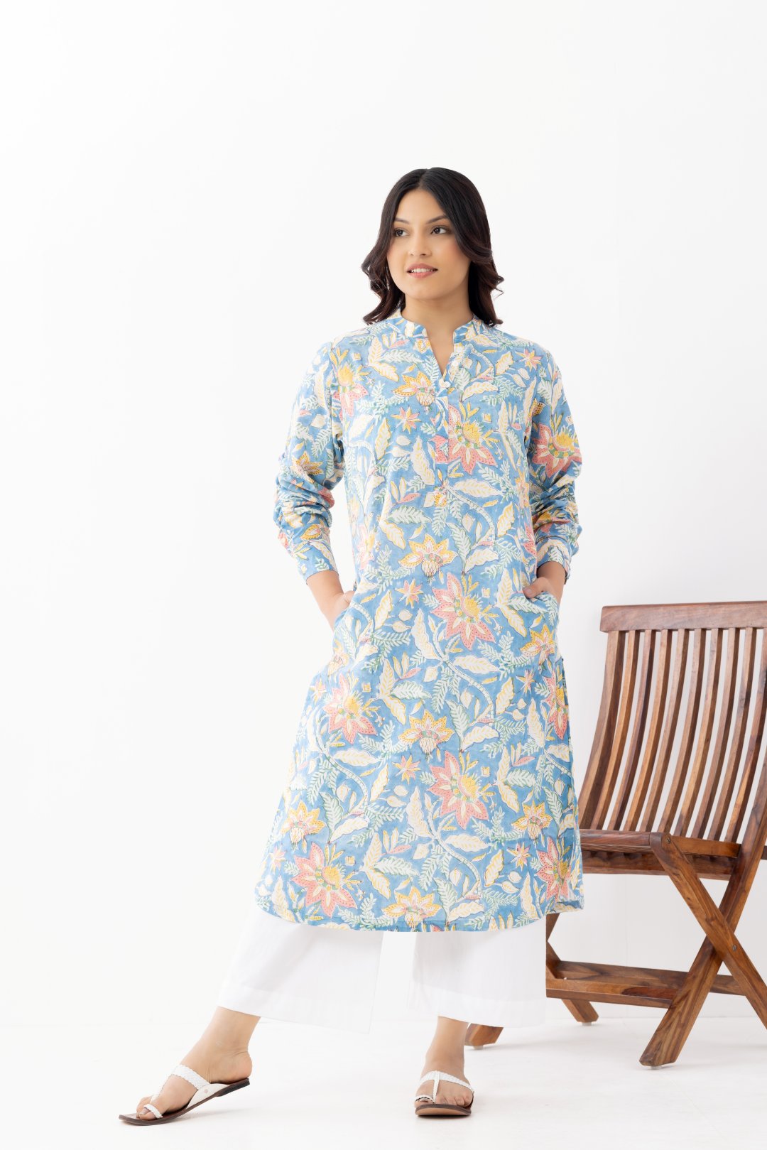 Woman wearing a pure linen cotton floral sky blue printed kurta with side pockets and mandarin collars