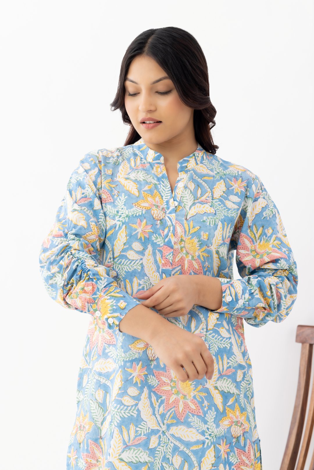 Woman wearing a pure linen cotton floral sky blue printed kurta with side pockets and mandarin collars