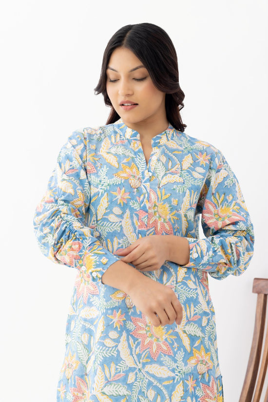 Woman wearing a pure linen cotton floral sky blue printed kurta with side pockets and mandarin collars