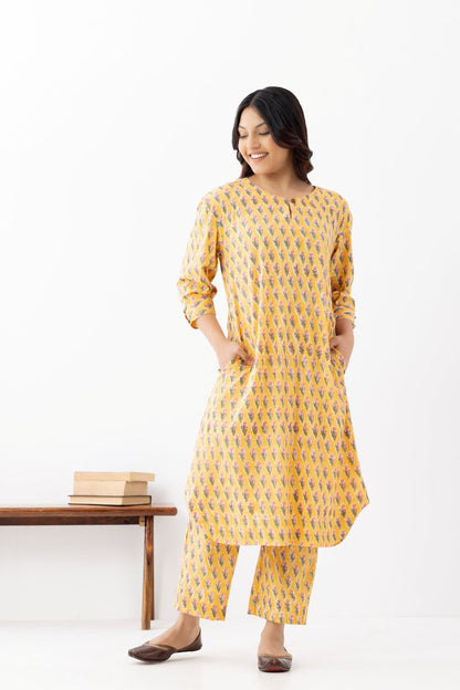 Woman wearing a pure linen booti printed yellow patterned kurta with matching pants and side pockets