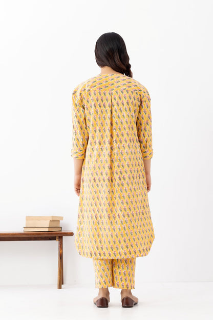 Woman wearing a pure linen booti printed yellow patterned kurta with matching pants and side pockets
