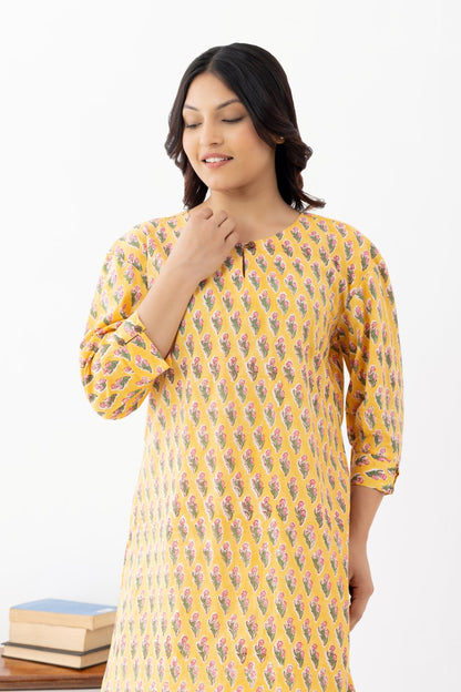 Woman wearing a pure linen booti printed yellow patterned kurta with matching pants and side pockets