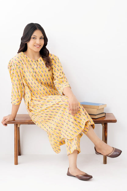 Woman wearing a pure linen booti printed yellow patterned kurta with matching pants and side pockets