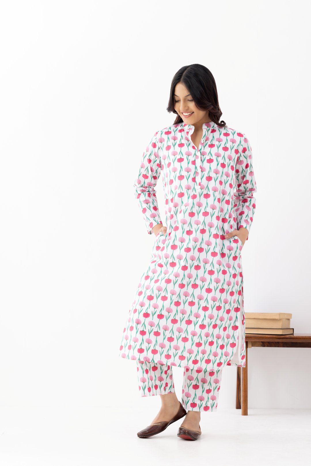 Woman wearing a floral White Pink Printed Co-ords Set With a Mandarin Collar and Side Pockets