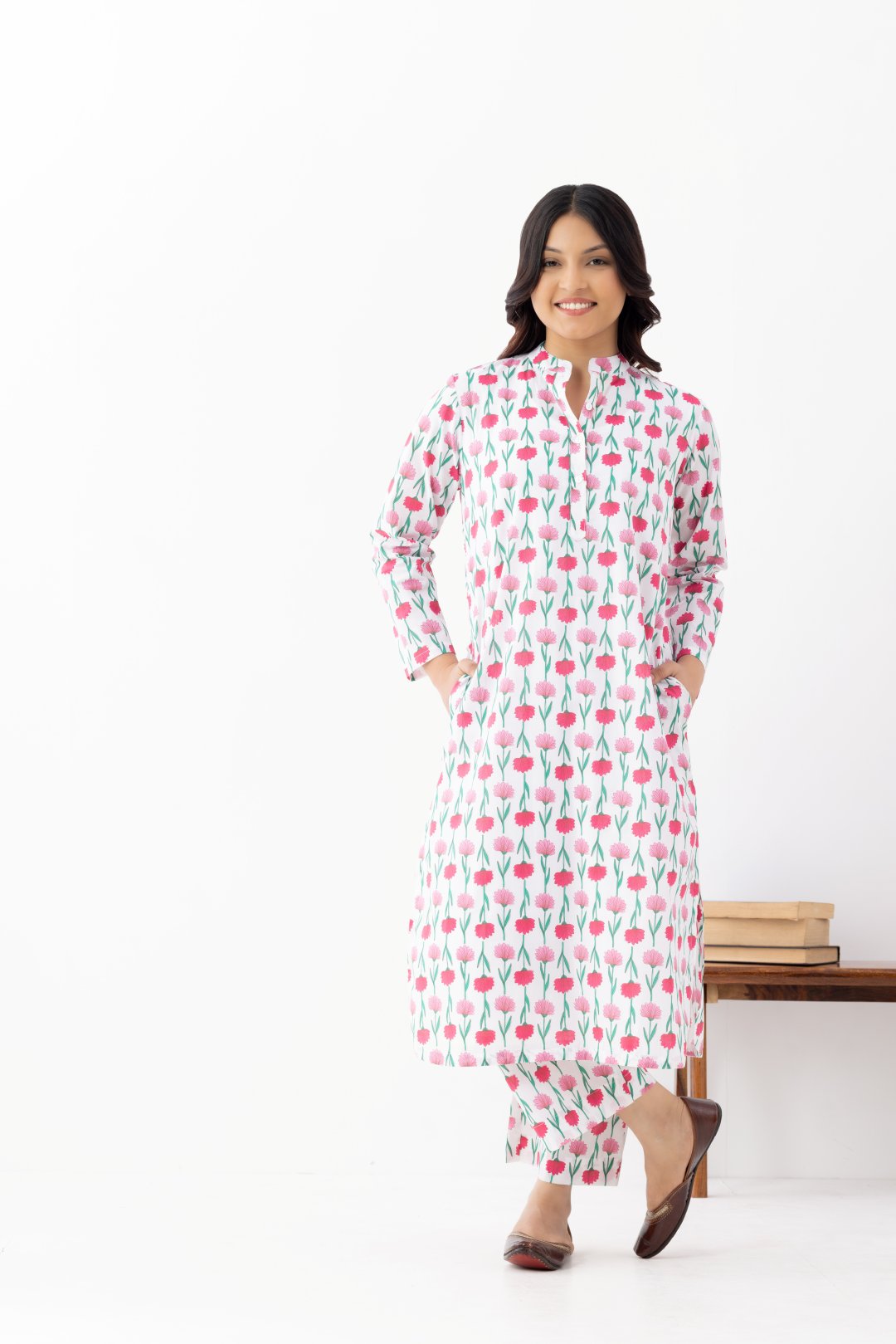 Woman wearing a floral White Pink Printed Co-ords Set With a Mandarin Collar and Side Pockets