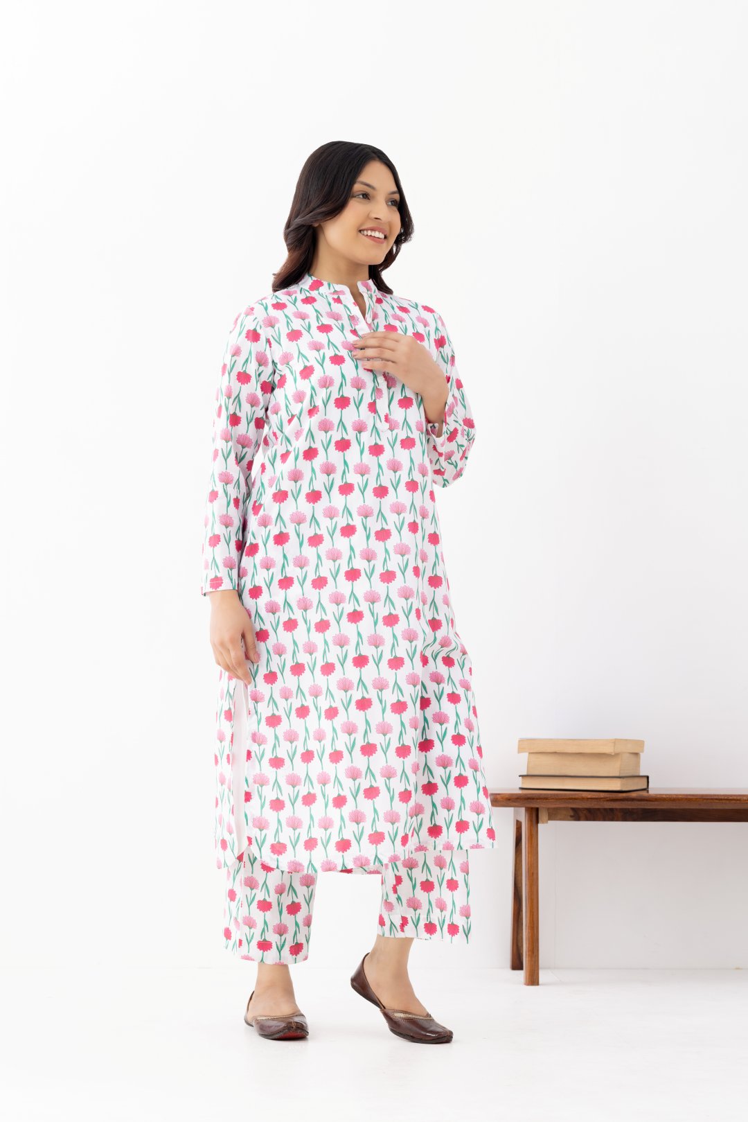 Woman wearing a floral White Pink Printed Co-ords Set With a Mandarin Collar and Side Pockets