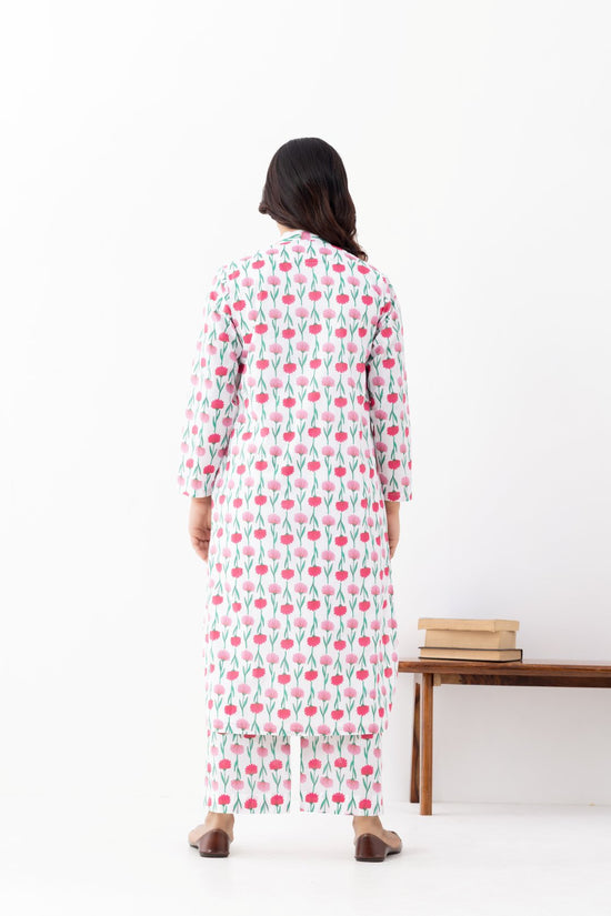 Woman wearing a floral White Pink Printed Co-ords Set With a Mandarin Collar and Side Pockets