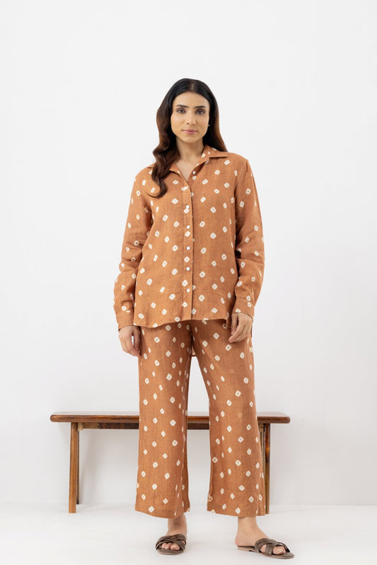 Woman wearing a brown polka dot line co-ords outfit 