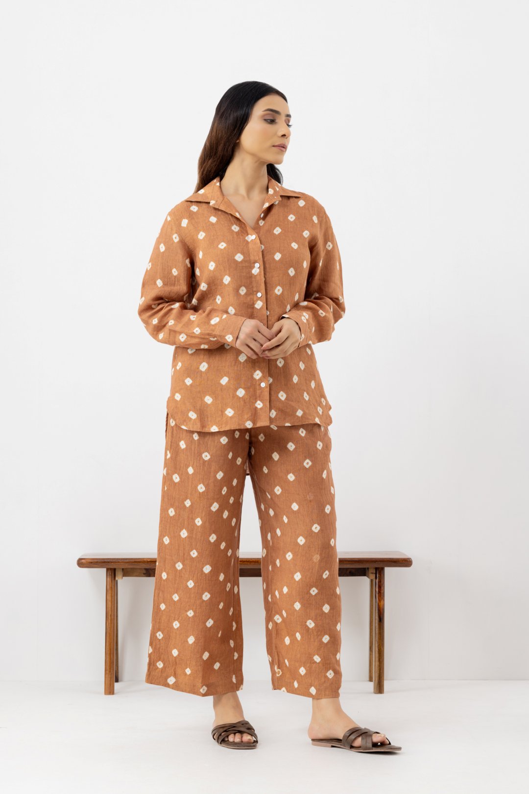 Woman wearing a brown polka dot line co-ords outfit 