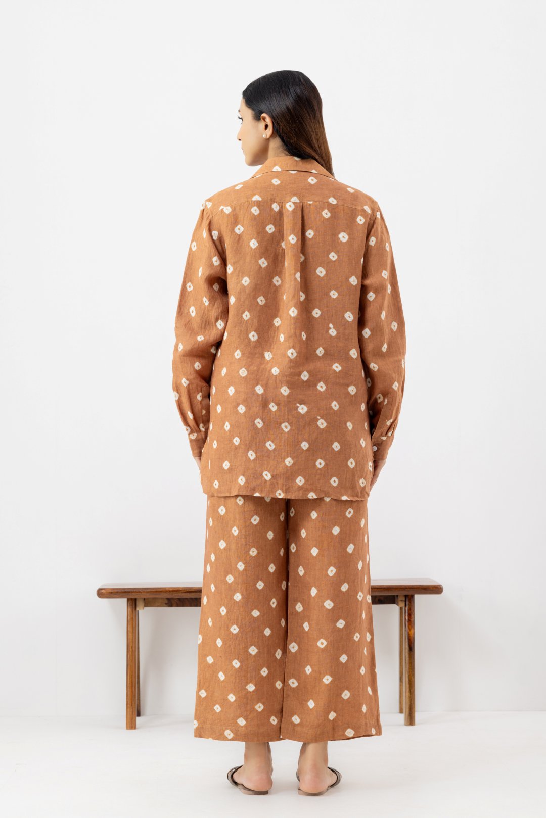 Woman wearing a brown polka dot line co-ords outfit 