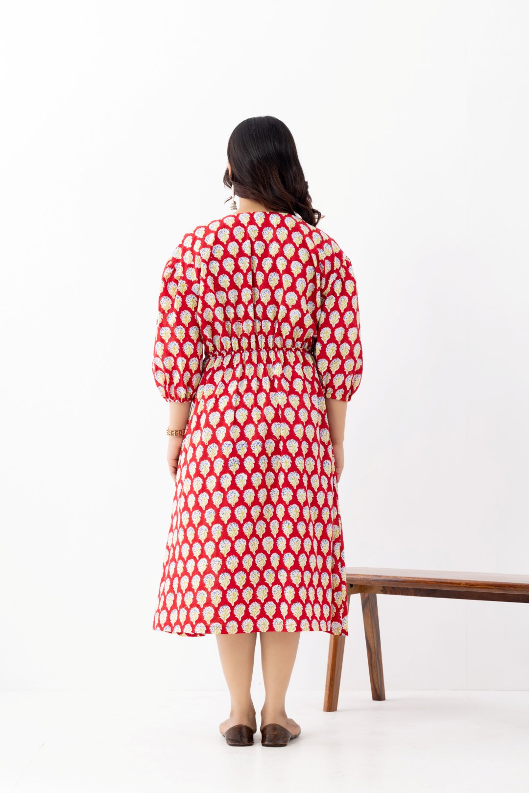 Woman wearing a pure linen cotton comfortable red and white block printed patterned dress with side pockets and 3/4th sleeves pockets