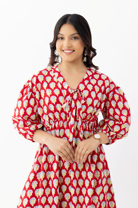 Woman wearing a pure linen cotton comfortable red and white block printed patterned dress with side pockets and 3/4th sleeves pockets