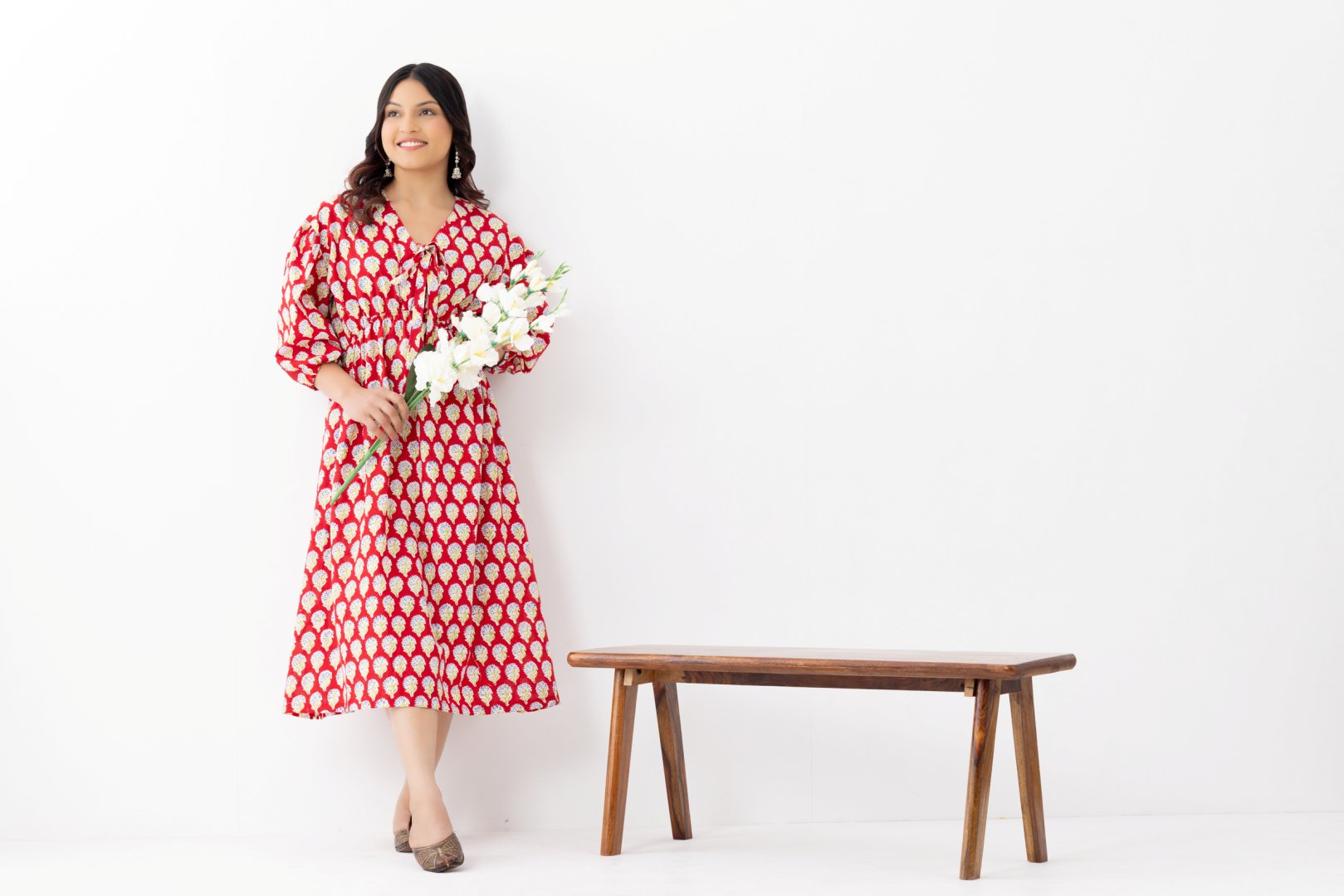 Woman wearing a pure linen cotton comfortable red and white block printed patterned dress with side pockets and 3/4th sleeves pockets