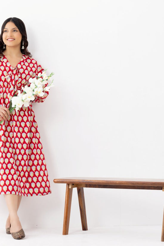 Woman wearing a pure linen cotton comfortable red and white block printed patterned dress with side pockets and 3/4th sleeves pockets