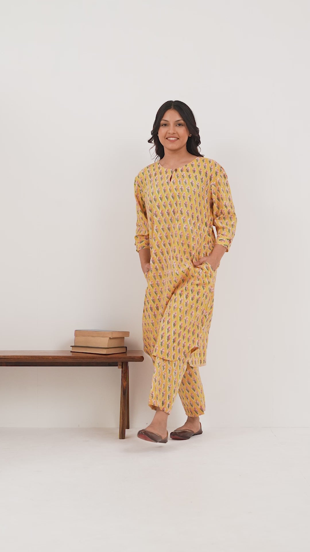 Woman wearing a pure linen booti printed yellow patterned kurta with matching pants and side pockets