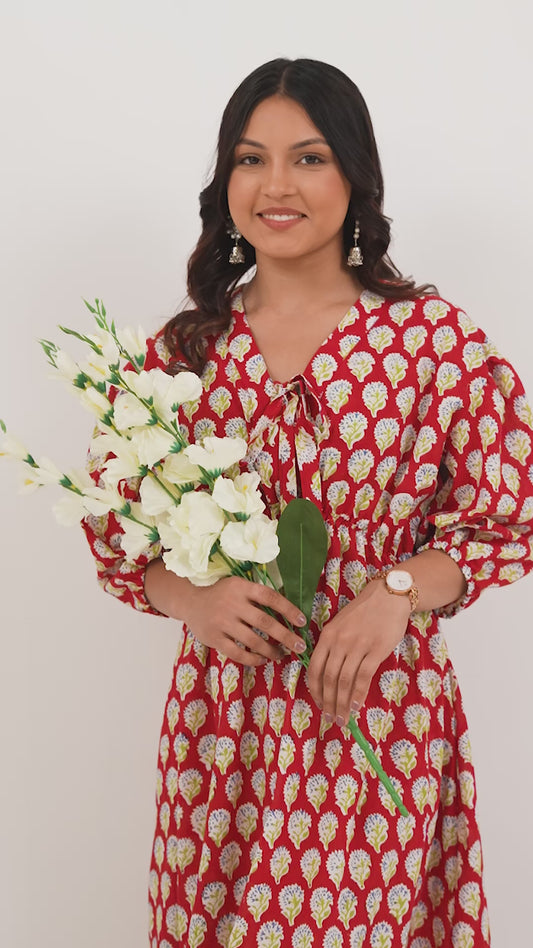 Woman wearing a pure linen cotton comfortable red and white block printed patterned dress with side pockets and 3/4th sleeves pockets